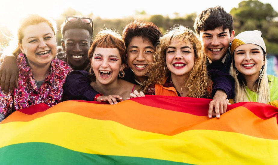 Young people holding rainbow flag